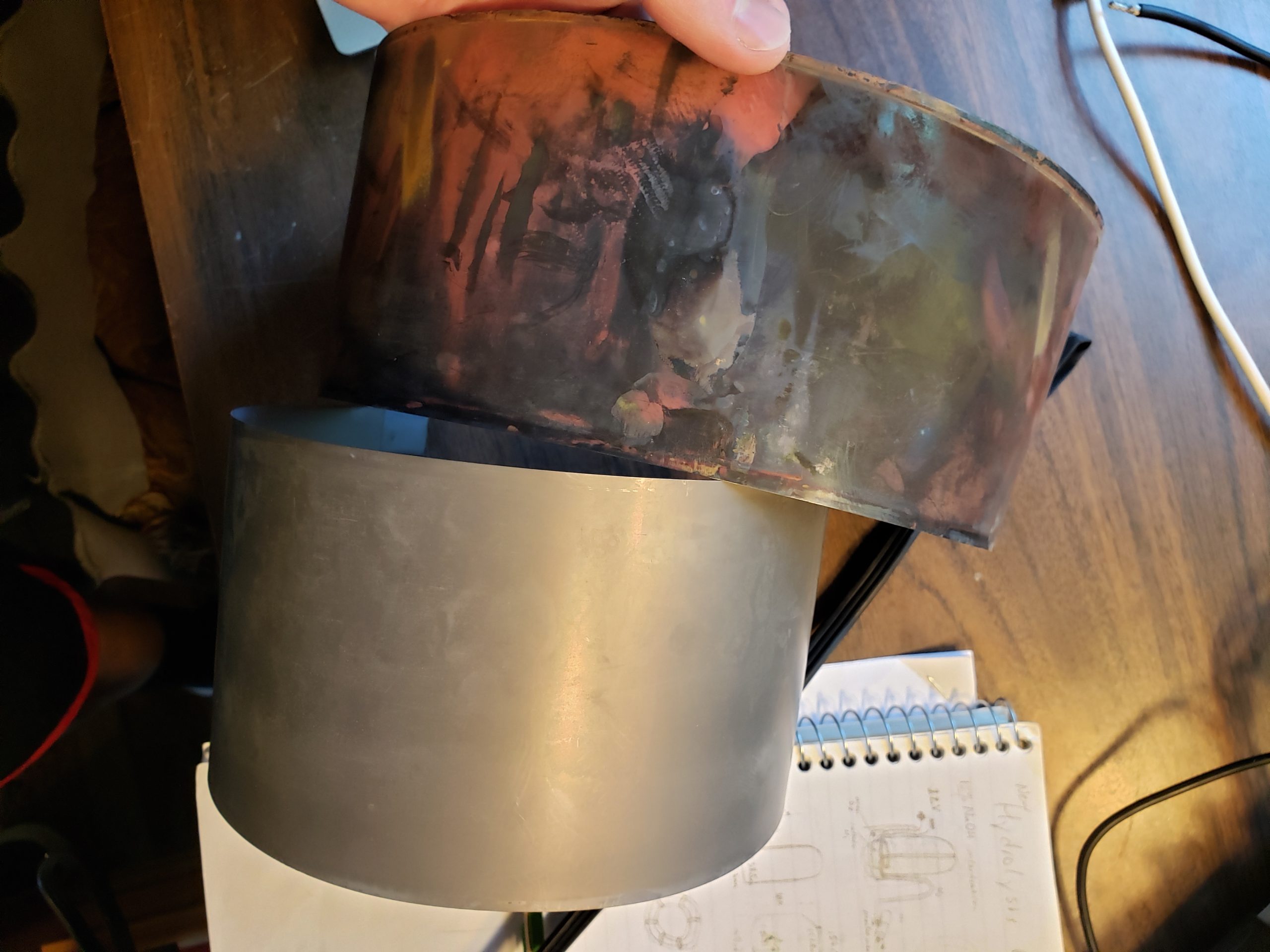 The red material is likely from side reactions with contaminants. The darker material is TiH2
